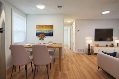 Dining room with visible vents, baseboards, and li