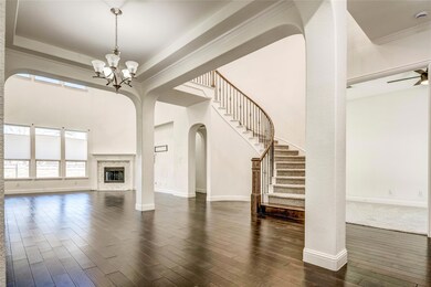 Unfurnished living room with a tray ceiling, a not