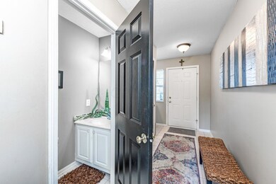 Entry showing door to half guest Bath