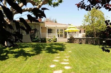Beautiful backyard with rear patio and lush landsc