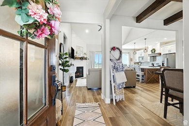 Foyer entrance with light wood-type flooring, a fireplace, and recessed lighting