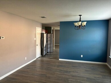 Spare room featuring an inviting chandelier and da
