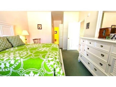 Bedroom featuring dark colored carpet
