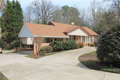 Front of House w/ Carport & Lots of Parking