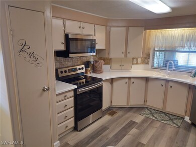 Kitchen with sink, light hardwood / wood-style flo