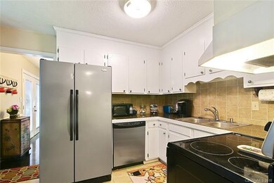 Kitchen with Granite Tile Countertops.