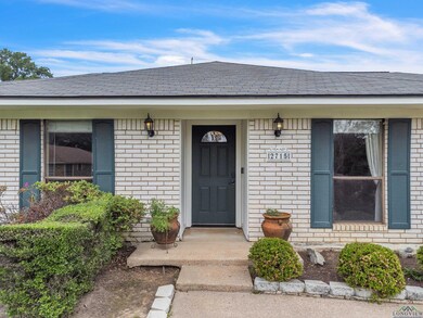 Property entrance with brick siding and a shingled roof