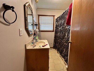 Bathroom featuring vanity, curtained shower, visib