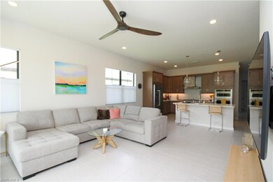 Tiled living room featuring ceiling fan