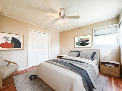 Bedroom featuring crown molding, wood finished floors, a closet, and ceiling fan
