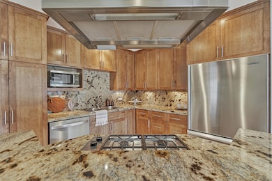 Granite countertops and backsplash nicely accent t