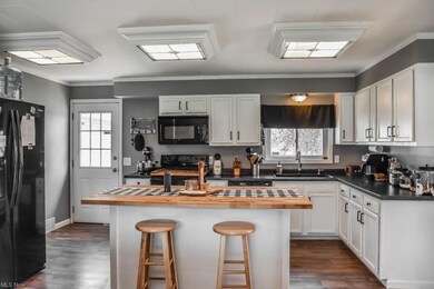 Updated, applianced kitchen features a center isla