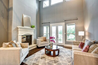 The formal living room has a two-story coffered ce