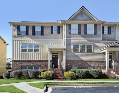 View of front facade featuring brick siding, uncovered parking, and board and batten siding