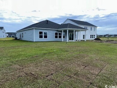 Back of property featuring a lawn