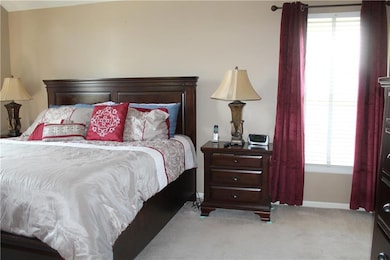 Carpeted bedroom with baseboards