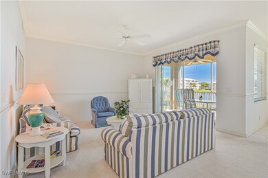 Carpeted living room with ceiling fan and ornament
