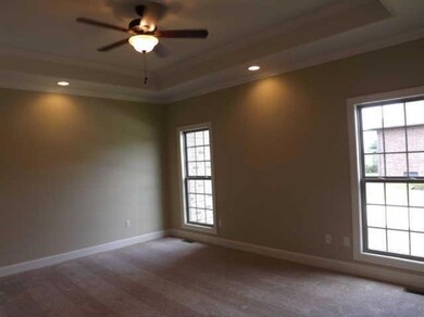 The master bedroom has a tray ceiling w/recessed lighting, crown molding, two sunny windows and zoned for privacy from the secondary bedrooms 