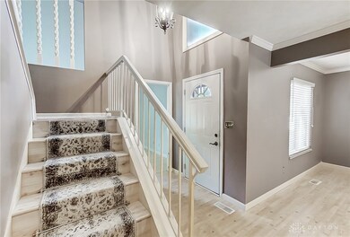 Upon entry, a soaring stairway with landing greets
