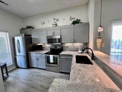 Kitchen featuring backsplash, stainless steel appl