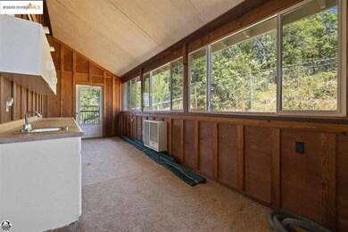 Unfurnished sunroom with vaulted ceiling and sink