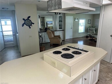 Kitchen featuring stove, white cabinetry, exhaust 