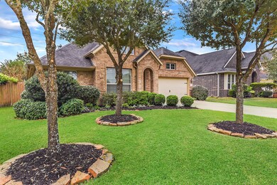 Beautifully landscaped yard with stone lining the flower beds.