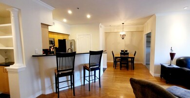 Kitchen featuring dark countertops, decorative col