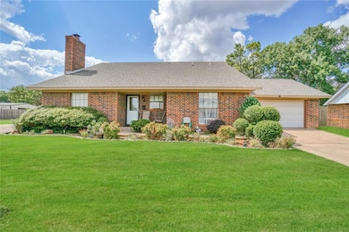 Ranch-style home featuring a front yard and a gara