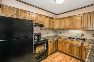 newer black refrigerator and range hood and stove/