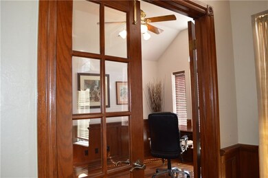 Glass and wood doors close off the office for privacy