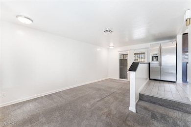 Kitchen featuring stainless steel fridge and light