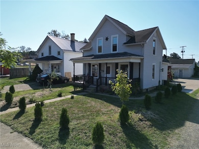 View of front of property with a porch and a front yard