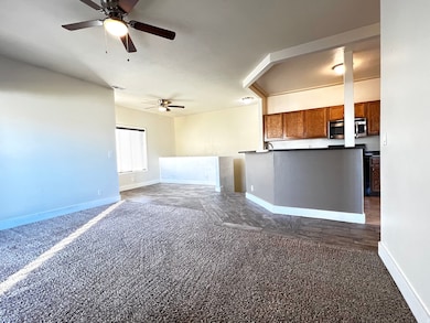 Living room opening up to dining and kitchen