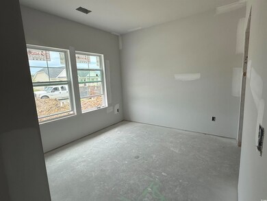 Unfurnished room with unfinished concrete floors