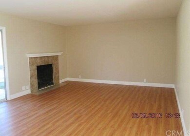 Large living area with tiled fireplace.