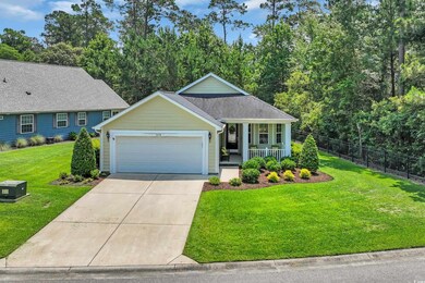 View of front facade featuring a porch, an attached garage, and driveway