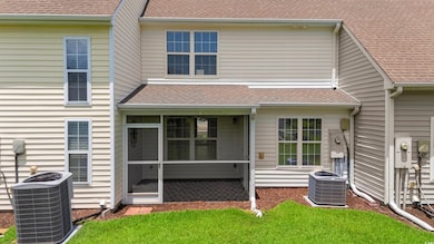 Rear view of house with a sunroom and roof with shingles