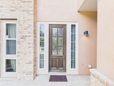 View of exterior entry with stucco siding