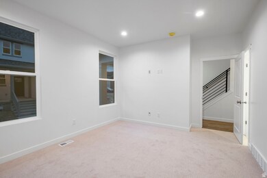 Unfurnished room featuring stairs, light colored carpet, and recessed lighting