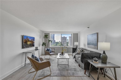 Living area with wood finished floors and a textured ceiling