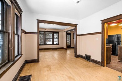 Unfurnished room with light hardwood / wood-style 