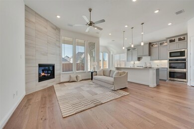 Unfurnished living room with a tile fireplace, lig