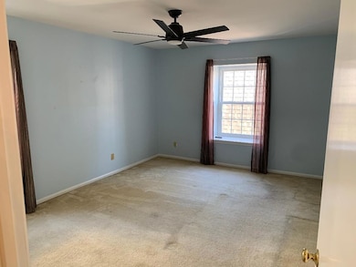 Carpeted empty room with ceiling fan