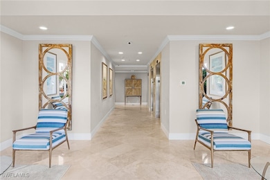 Hall with ornamental molding and light tile patterned flooring