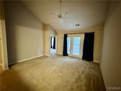  with carpet flooring, ceiling fan, and vaulted ce