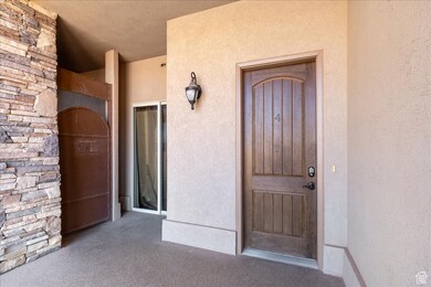 Entrance to property featuring stucco siding
