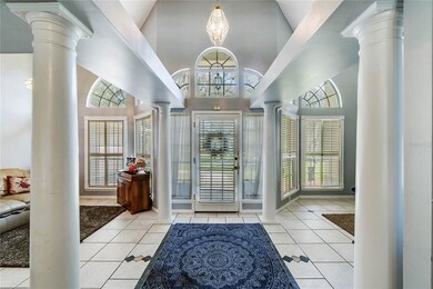 Grand tiled foyer with living room and dining room