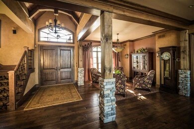 The wood enhanced foyer presents a stunning entry 