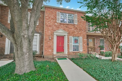 Charming two-story brick townhouse with a striking